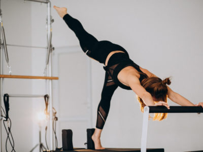 Woman doing pilates on a reformer